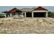 New construction home featuring concrete block walls, a two-car garage, and modern architectural design at 14735 Keystone Blvd, Port Charlotte, FL 33981