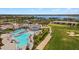 Aerial view showcasing the community's stunning resort-style pool and golf course at 15970 Grassland Ln # 2816, Punta Gorda, FL 33982