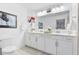 Bright bathroom featuring a double sink vanity with white cabinets and a large mirror at 15970 Grassland Ln # 2816, Punta Gorda, FL 33982