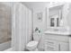 Cozy bathroom featuring a toilet, shower with curtain, and sink with countertop at 15970 Grassland Ln # 2816, Punta Gorda, FL 33982