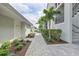 Exterior shot of condo buildings with a paved walkway and manicured landscaping at 15970 Grassland Ln # 2816, Punta Gorda, FL 33982