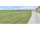 Scenic view of a lush green golf course with a smooth cart path and beautiful buildings at 15970 Grassland Ln # 2816, Punta Gorda, FL 33982