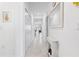 Bright hallway with white walls and tile flooring, leading to the kitchen and living area at 15970 Grassland Ln # 2816, Punta Gorda, FL 33982