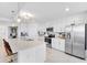 Modern kitchen with stainless steel appliances and bar stool seating at 15970 Grassland Ln # 2816, Punta Gorda, FL 33982