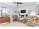 Open living room features a fireplace, fan, and a view of the outdoors at 15970 Grassland Ln # 2816, Punta Gorda, FL 33982