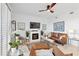 Cozy living room featuring a fireplace, ceiling fan, and comfortable seating at 15970 Grassland Ln # 2816, Punta Gorda, FL 33982