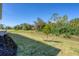 Spacious backyard featuring well-maintained lawn and views of the surrounding landscape at 16579 Cape Horn Blvd, Punta Gorda, FL 33955