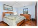 Bright bedroom with blue walls, natural light from the window, and unique tiled flooring throughout the room at 1701 Overbrook Rd, Englewood, FL 34223