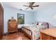 Bright bedroom featuring a window for natural light, unique tiled flooring, and neutral paint throughout the room at 1701 Overbrook Rd, Englewood, FL 34223