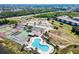 Aerial view showing the community pool, tennis courts, parking and the building location at 175 Kings Hwy # 232, Punta Gorda, FL 33983