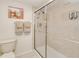 Tiled bathroom with glass-enclosed shower and convenient wall-mounted soap dispensers at 175 Kings Hwy # 232, Punta Gorda, FL 33983