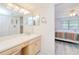Bright bathroom vanity with ample lighting and access to an adjacent bedroom at 175 Kings Hwy # 232, Punta Gorda, FL 33983