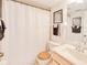 Cozy bathroom with a shower curtain, light wood vanity, and matching toilet seat at 175 Kings Hwy # 232, Punta Gorda, FL 33983