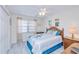 Comfortable bedroom with a ceiling fan, side tables and natural light from the window at 175 Kings Hwy # 232, Punta Gorda, FL 33983