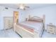 Cozy bedroom featuring a decorative ceiling fan, dresser, and nightstands at 175 Kings Hwy # 232, Punta Gorda, FL 33983