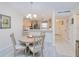 Bright dining area featuring a chandelier and views into the kitchen at 175 Kings Hwy # 232, Punta Gorda, FL 33983