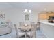 Cozy dining area with a chandelier and views into the living room and kitchen at 175 Kings Hwy # 232, Punta Gorda, FL 33983