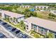 View of the condo complex with ample parking, green spaces, and well-maintained landscaping at 175 Kings Hwy # 232, Punta Gorda, FL 33983