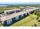 Condo complex with screened balconies, green spaces, and easy access to parking at 175 Kings Hwy # 232, Punta Gorda, FL 33983