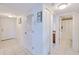 Neutral hallway with tile flooring, leading to various rooms and storage spaces at 175 Kings Hwy # 232, Punta Gorda, FL 33983