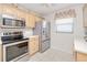 Modern kitchen showcases stainless steel appliances, light cabinets, and tile flooring at 175 Kings Hwy # 232, Punta Gorda, FL 33983