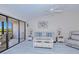 Comfortable living room with a ceiling fan and access to the screened lanai at 175 Kings Hwy # 232, Punta Gorda, FL 33983