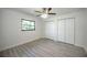 Bedroom featuring light gray floors, a ceiling fan, closet, and window at 21229 Giddings Ave, Port Charlotte, FL 33952