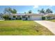 Charming single-story home featuring a well-manicured lawn and an attached two-car garage at 21229 Giddings Ave, Port Charlotte, FL 33952