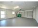 Spacious two car garage with smooth concrete floor, fluorescent lighting and large garage door at 21229 Giddings Ave, Port Charlotte, FL 33952