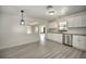 Bright kitchen features white cabinets, modern appliances, and neutral granite countertops with an open view to the dining area at 21229 Giddings Ave, Port Charlotte, FL 33952