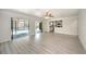 Bright, open living room with new floors and views of the kitchen and a screened-in pool area at 21229 Giddings Ave, Port Charlotte, FL 33952