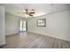 Living room featuring light gray floors, a ceiling fan, and access to the outdoor pool area at 21229 Giddings Ave, Port Charlotte, FL 33952