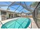Beautiful screened in-ground pool with extended patio and lush backyard at 21229 Giddings Ave, Port Charlotte, FL 33952