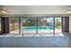 Enclosed pool area featuring a screened-in enclosure and a view of the backyard at 21229 Giddings Ave, Port Charlotte, FL 33952