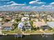 An elevated view highlights a home's tranquil waterfront setting, complete with a dock and pool at 2181 Via Seville, Punta Gorda, FL 33950