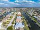 An aerial view showcases the home's location on a canal, surrounded by lush landscaping at 2181 Via Seville, Punta Gorda, FL 33950