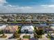 Stunning aerial view of waterfront home, showcasing its pristine landscaping, paver driveway, and convenient boat access at 2181 Via Seville, Punta Gorda, FL 33950