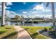 Waterfront backyard featuring a boat lift providing direct access to the canal for boating and water activities at 2181 Via Seville, Punta Gorda, FL 33950