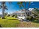 Spacious screened-in lanai with a lush backyard featuring palm trees and direct access to the canal at 2181 Via Seville, Punta Gorda, FL 33950