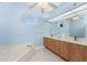 Bathroom featuring double vanity, a bathtub, a large mirror, and seashell-themed decorations at 2181 Via Seville, Punta Gorda, FL 33950