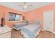 Comfortable bedroom with two beds, natural light, and a ceiling fan at 2181 Via Seville, Punta Gorda, FL 33950