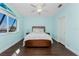 This spacious bedroom features wood floors, ceiling fan, and light blue walls at 2181 Via Seville, Punta Gorda, FL 33950
