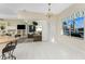 Bright dining area with a water view through a sliding glass door to an outdoor living space at 2181 Via Seville, Punta Gorda, FL 33950