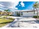 Well-manicured front yard and paver driveway lead to this home with an attached two-car garage at 2181 Via Seville, Punta Gorda, FL 33950