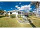 Beautiful waterfront property with lush landscaping, screened in pool, and private dock at 2181 Via Seville, Punta Gorda, FL 33950