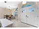 Open foyer with dining table featuring tile flooring, arched doorways, and natural light at 2181 Via Seville, Punta Gorda, FL 33950
