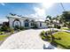 Well-manicured front yard and paver driveway lead to this home with an attached two-car garage at 2181 Via Seville, Punta Gorda, FL 33950