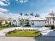 Beautiful single-story home featuring a well-manicured lawn, circular driveway and attached two-car garage at 2181 Via Seville, Punta Gorda, FL 33950
