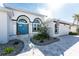 Charming front exterior featuring a well-manicured lawn, a paver driveway, and an inviting entrance with stone steps at 2181 Via Seville, Punta Gorda, FL 33950
