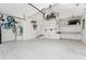 Bright, spacious garage with storage cabinets, ceiling fan, and utility sink at 2181 Via Seville, Punta Gorda, FL 33950